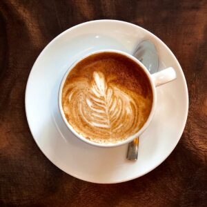 white ceramic teacup with latte